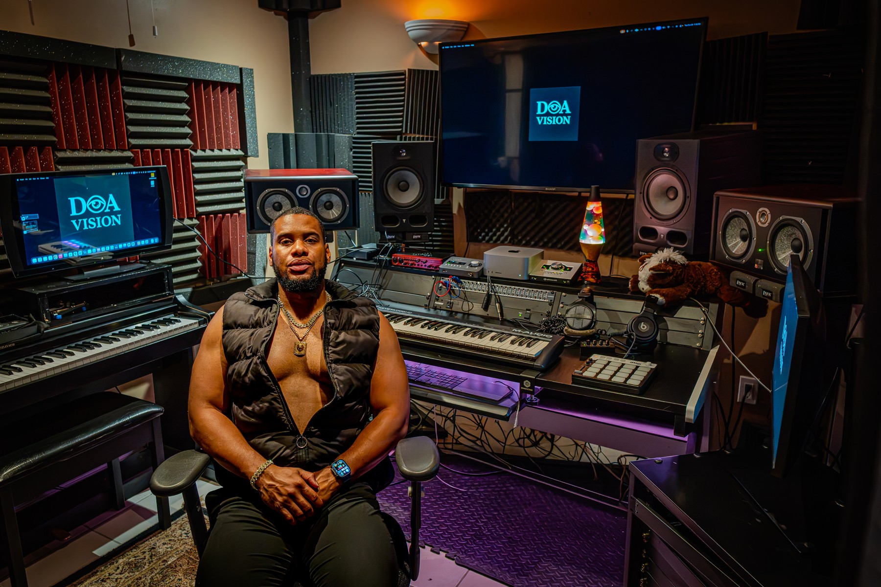 Daniel Amos, D.A One, seated at his studio desk